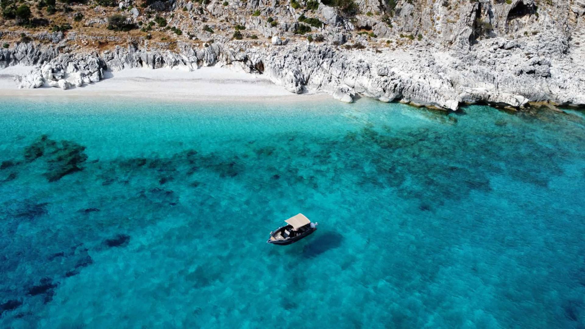Small motorboat on crystal clear turquoise water near Skala, Kefalonia